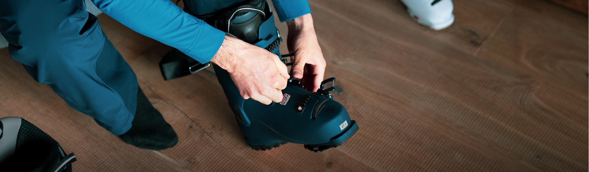 Ski boot fitting. A person trying on a ski boot
